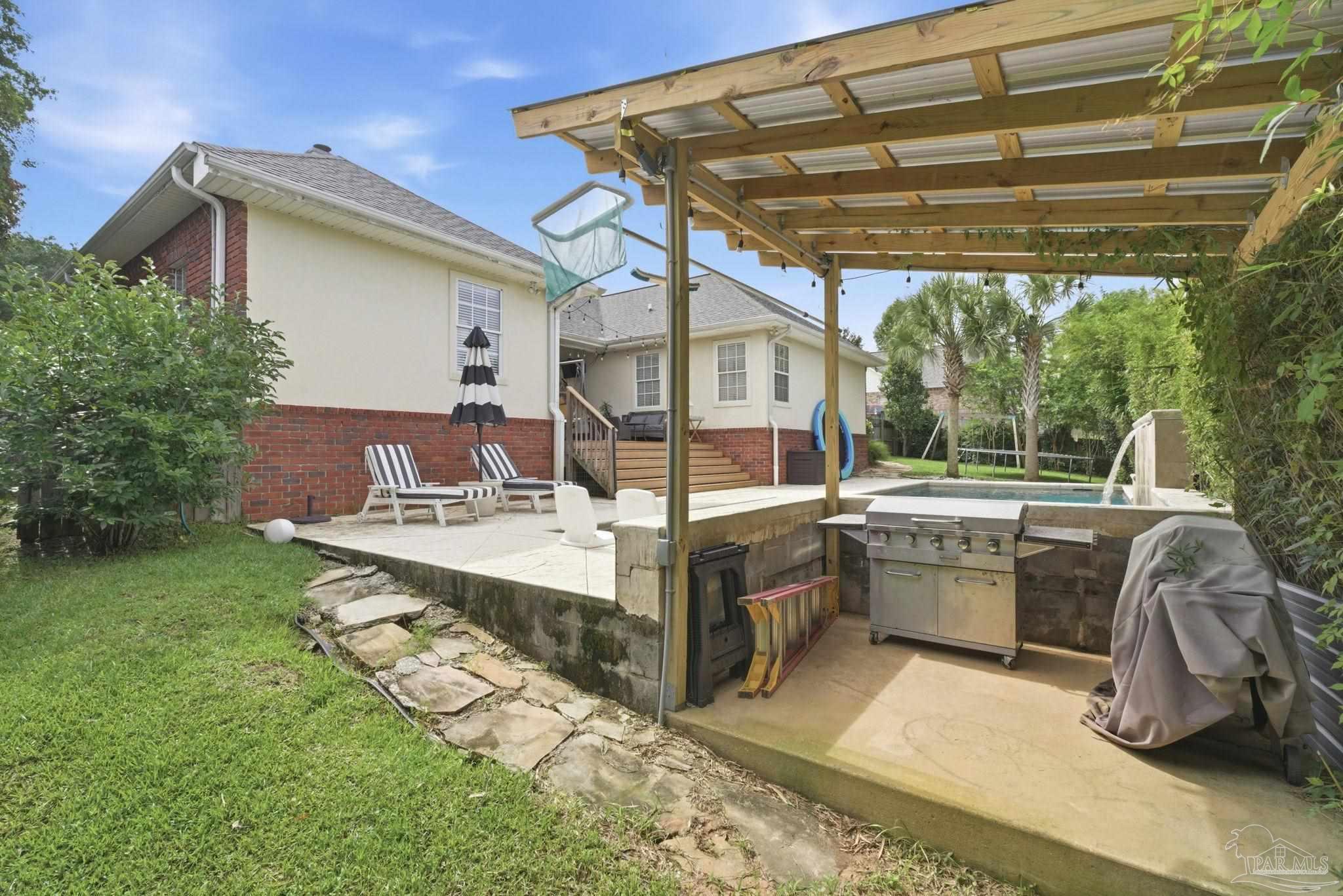 5931 Otter Point Road Pensacola, FL 32504 - Photo 50 of 67 a view of a patio with a table chairs and a barbeque