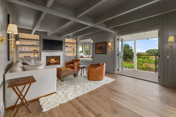 a living room with furniture a fireplace and a table