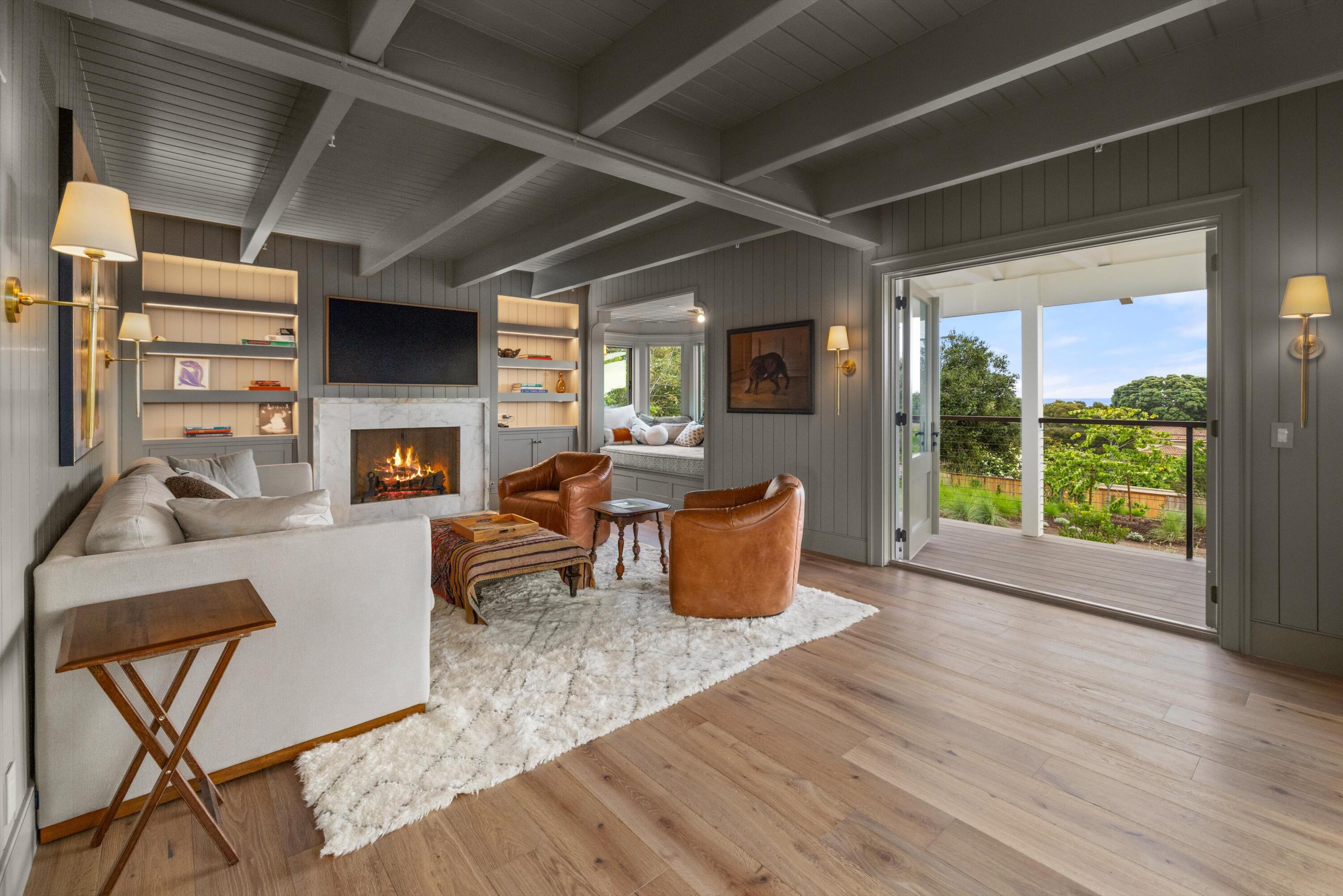7 Yankee Farm Road Santa Barbara, CA 93109 - Photo 12 of 33 a living room with furniture a fireplace and a table
