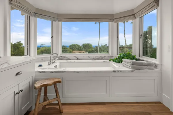 a view of cabinets a sink and a kitchen island