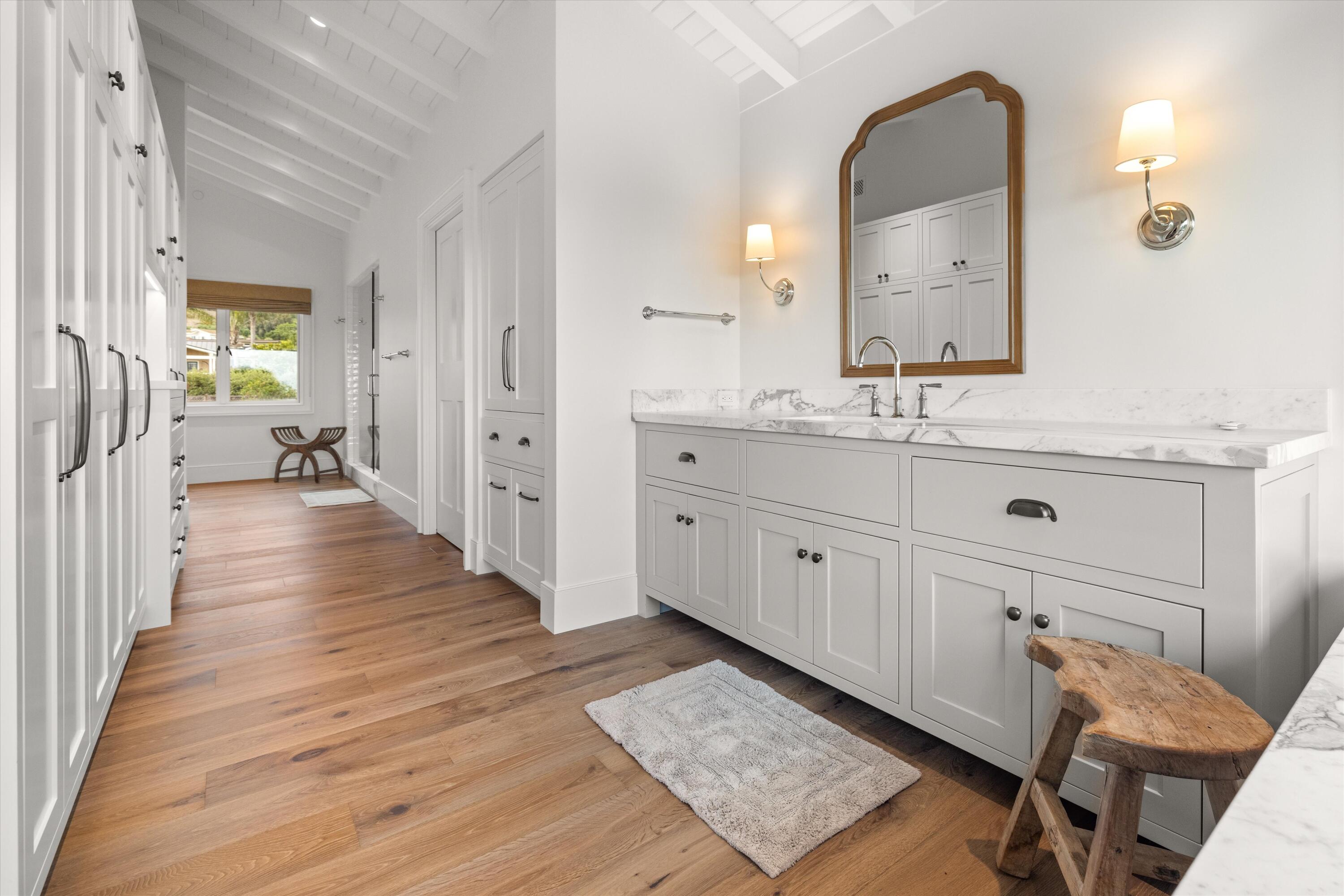 7 Yankee Farm Road Santa Barbara, CA 93109 - Photo 16 of 33 a spacious bathroom with a granite countertop sink a mirror a toilet and a bathtub