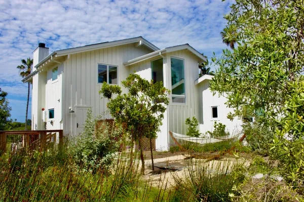 a front view of a house with garden