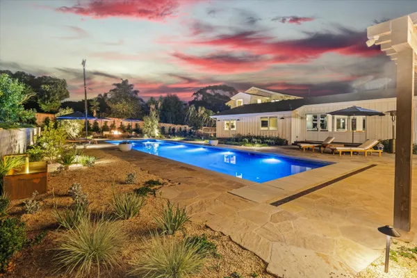 a view of swimming pool with outdoor seating