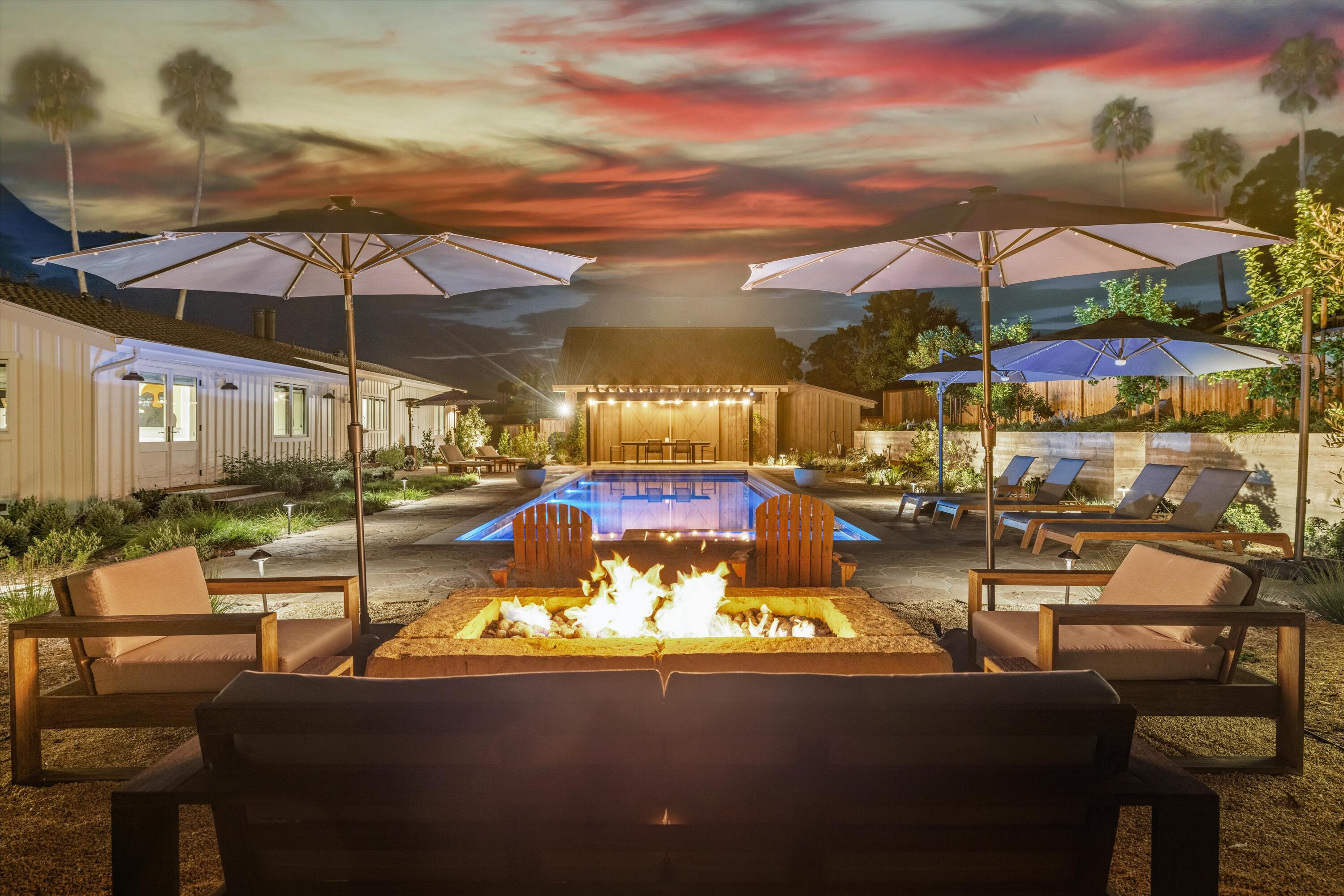 7 Yankee Farm Road Santa Barbara, CA 93109 - Photo 28 of 33 a view of a patio with couches chairs under an umbrella