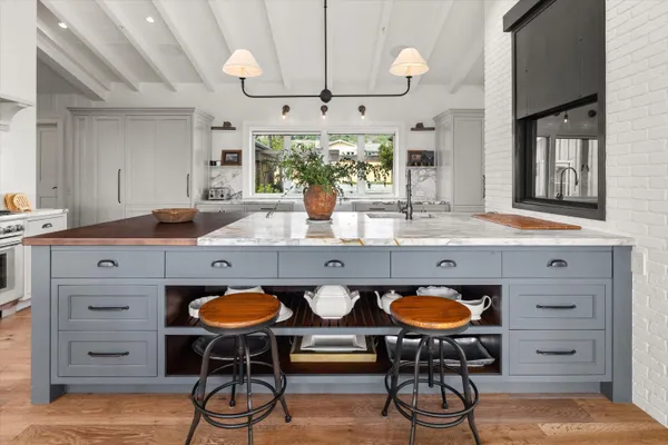 a kitchen with a table chairs and cabinets