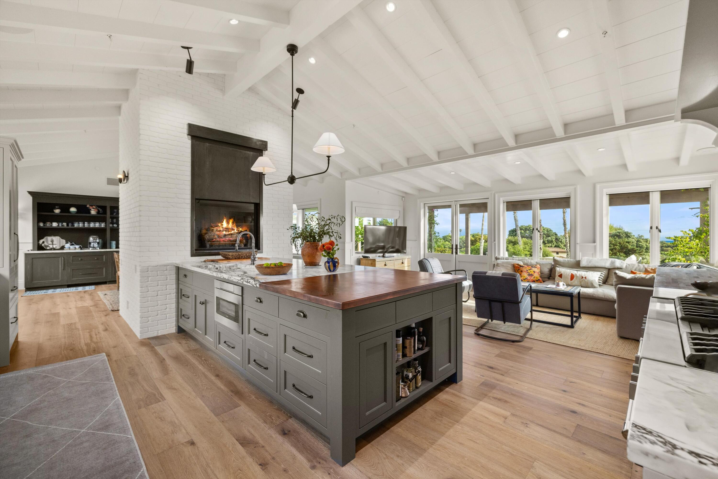 7 Yankee Farm Road Santa Barbara, CA 93109 - Photo 6 of 33 a kitchen with stainless steel appliances kitchen island granite countertop a stove a sink a refrigerator and a living room view