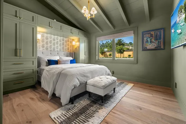 a bed sitting in a bedroom next to a window