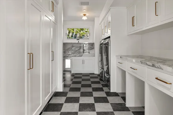 a kitchen with a refrigerator a sink and cabinets