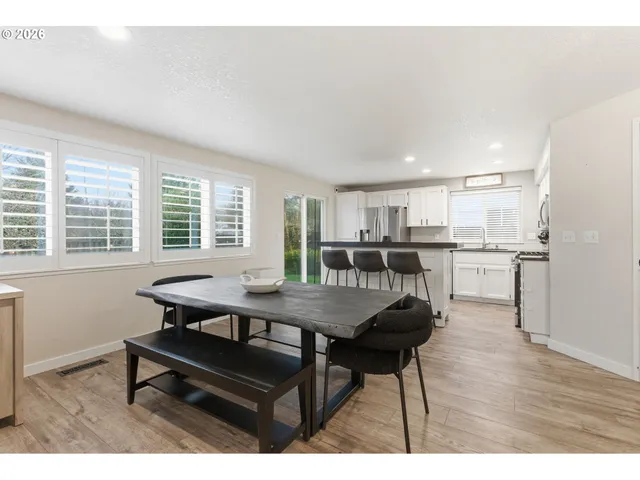 a view of a dining room with furniture and wooden floor