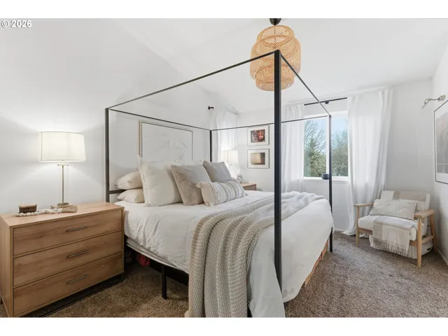 a bedroom with a bed and a mirror