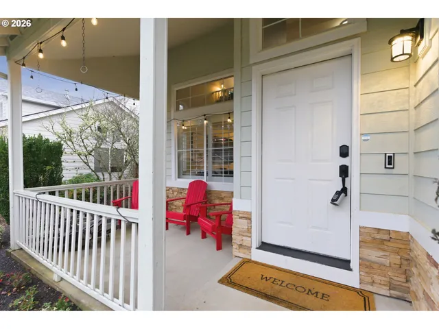 a view of a porch with a table and chairs