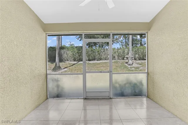 a view of a room with window and an empty room