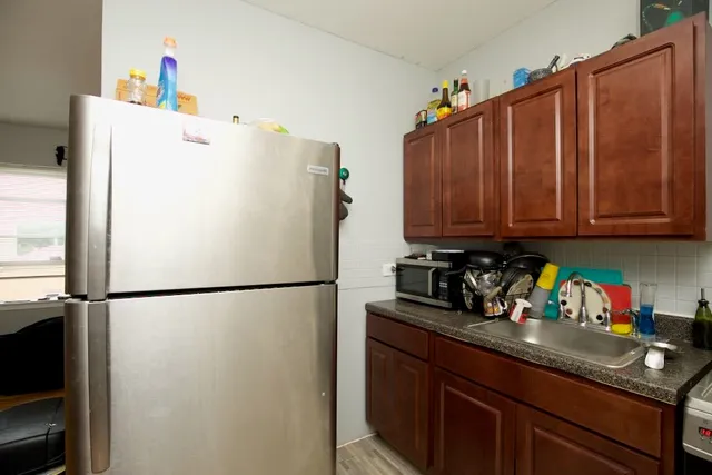 a white refrigerator freezer sitting in a kitchen with a refrigerator