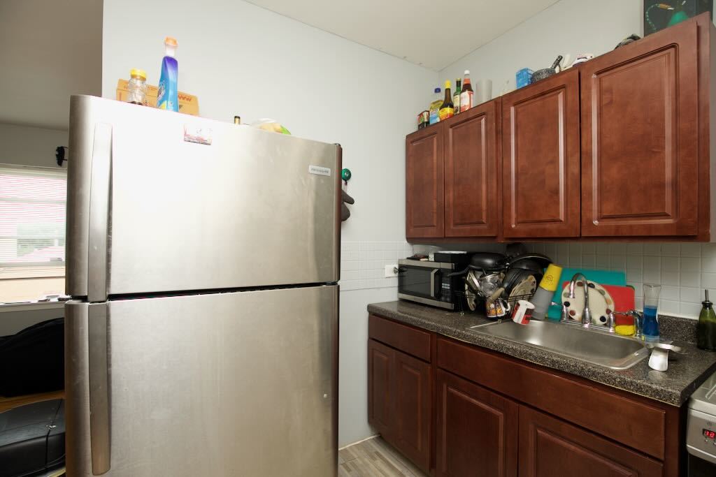 4511 Malden Street, Unit 3B Chicago, IL 60640 - Photo 11 of 20 a white refrigerator freezer sitting in a kitchen with a refrigerator