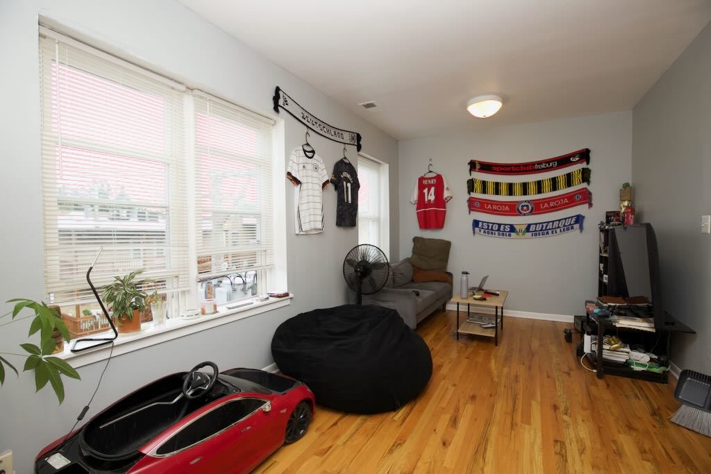 4511 Malden Street, Unit 3B Chicago, IL 60640 - Photo 3 of 20 a living room with furniture and a floor to ceiling window