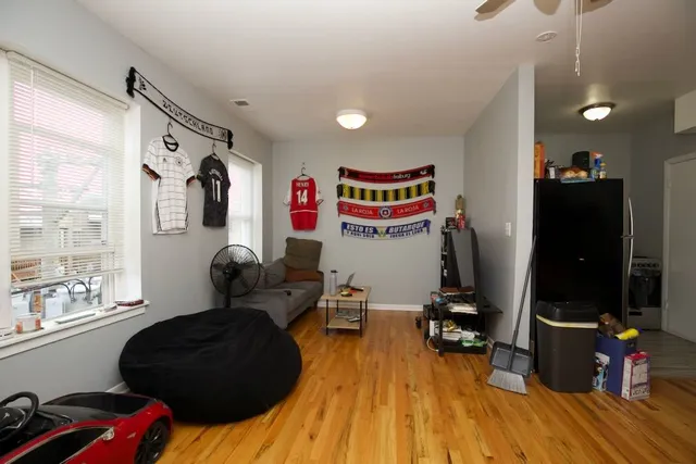 a living room with furniture and wooden floor