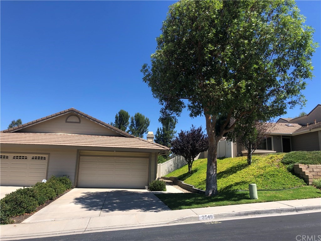 3549 Doe Spring Road Corona, CA 92882 - Photo 1 of 1 a front view of a house with a garden