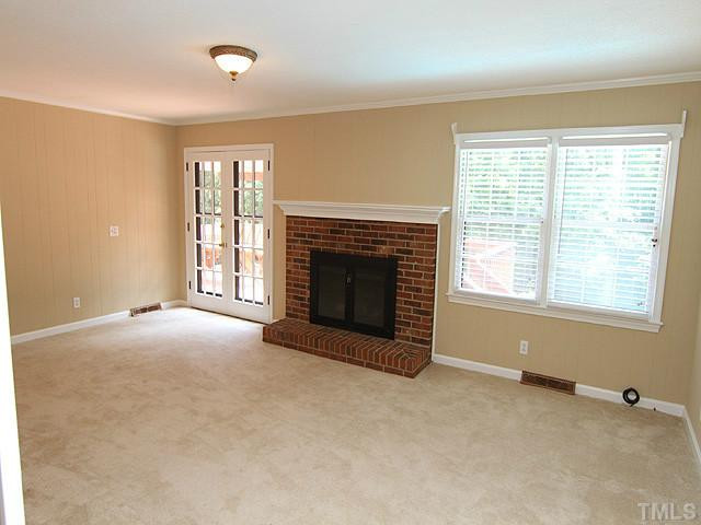 423 Oakridge Road Cary, NC 27511 - Photo 10 of 25 Fireplace in living room with access to the back deck! Den/Family/Great Room