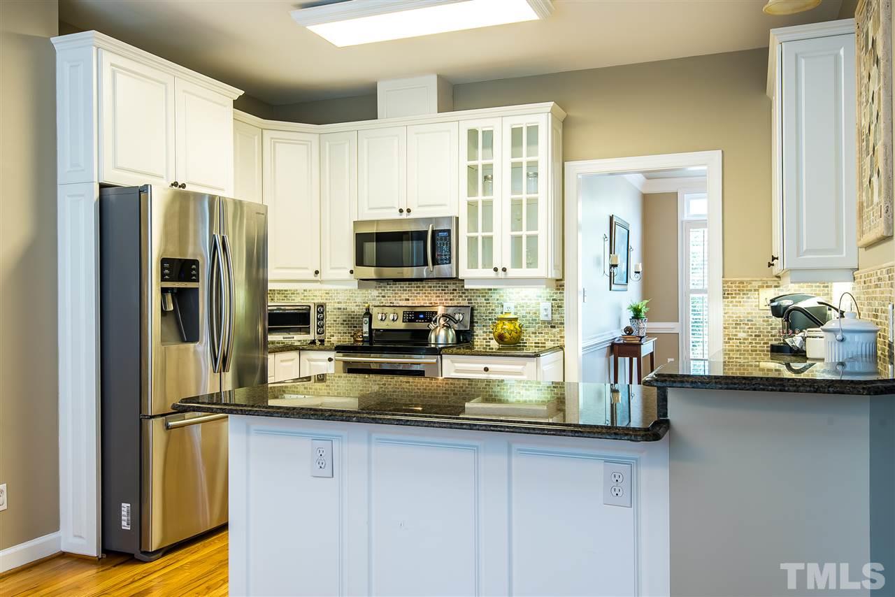 8200 Eden Close Court Raleigh, NC 27613 - Photo 2 of 15 a kitchen with stainless steel appliances a sink a refrigerator and a counter space