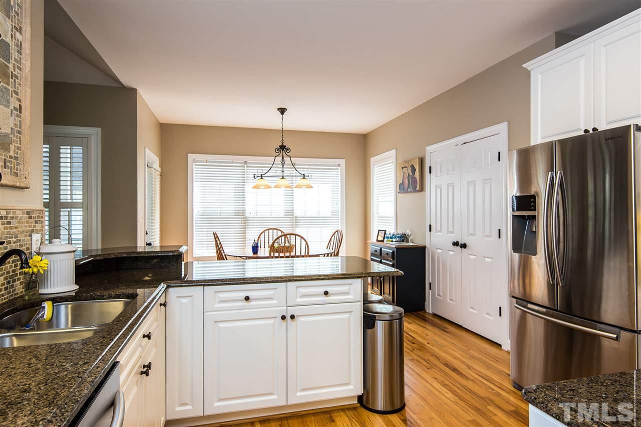 8200 Eden Close Court Raleigh, NC 27613 - Photo 3 of 15 a kitchen with stainless steel appliances granite countertop a sink stove and refrigerator
