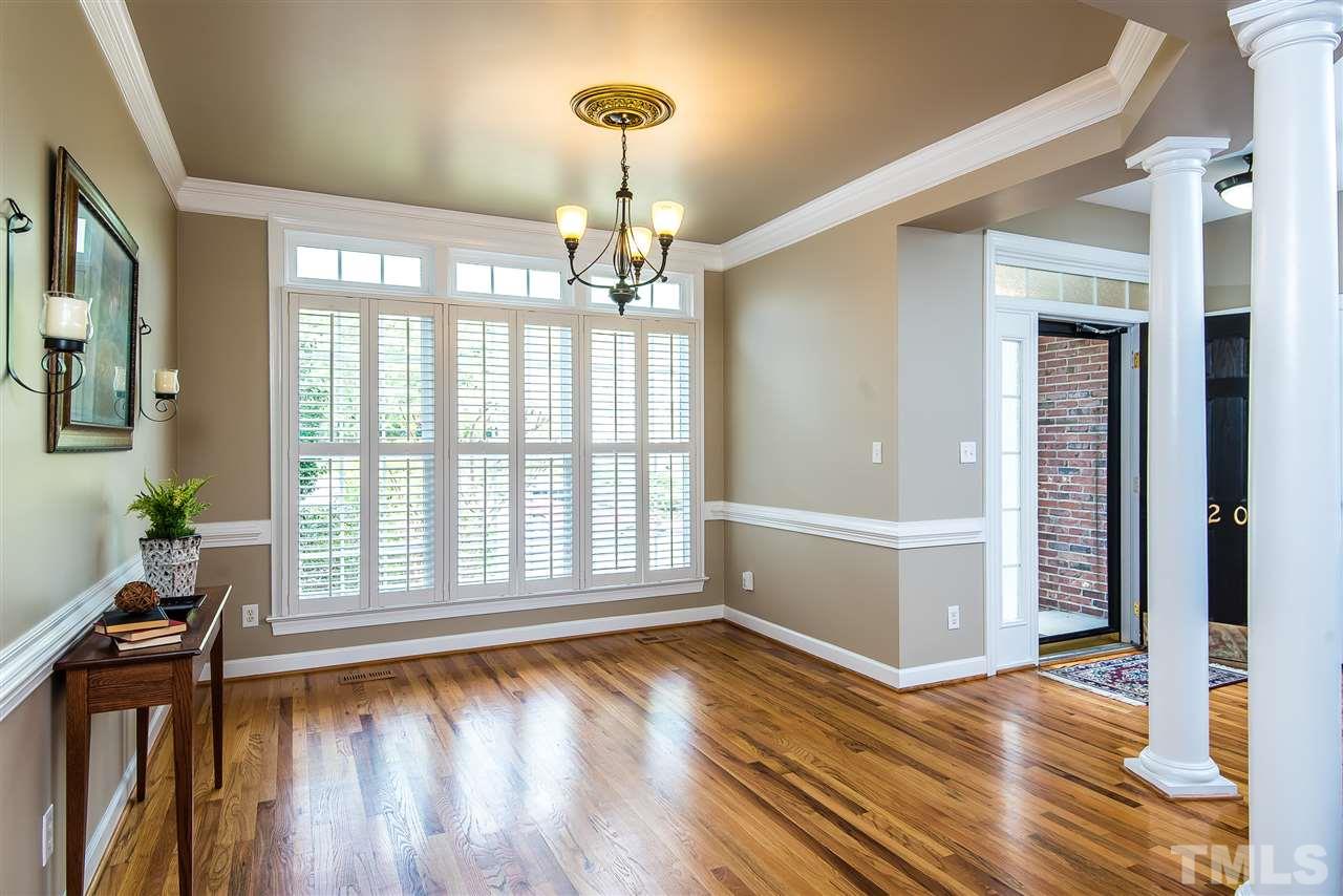 8200 Eden Close Court Raleigh, NC 27613 - Photo 4 of 15 a view of an empty room with wooden floor and a window