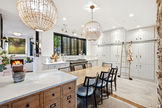5971 Maple Ridge Trail Oakley, UT 84055 - Photo 16 of 43 Gourmet kitchen featuring extensive white cabinetry with gold-toned hardware, an oversized central island with wood-finish drawers, and a professional-grade range