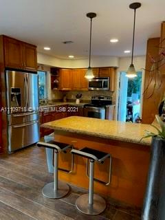 49 Southwest 9th Avenue Boca Raton, FL 33486 - Photo 2 of 8 a kitchen with stainless steel appliances granite countertop a sink a stove and a refrigerator