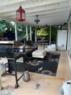 49 Southwest 9th Avenue Boca Raton, FL 33486 - Photo 7 of 8 a living room with patio furniture and a potted plant