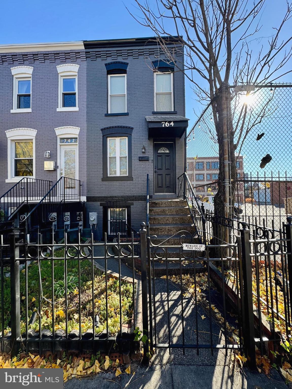 764 Morton Street Northwest Washington, DC 20010 - Photo 1 of 23 a view of a brick house with wooden fence