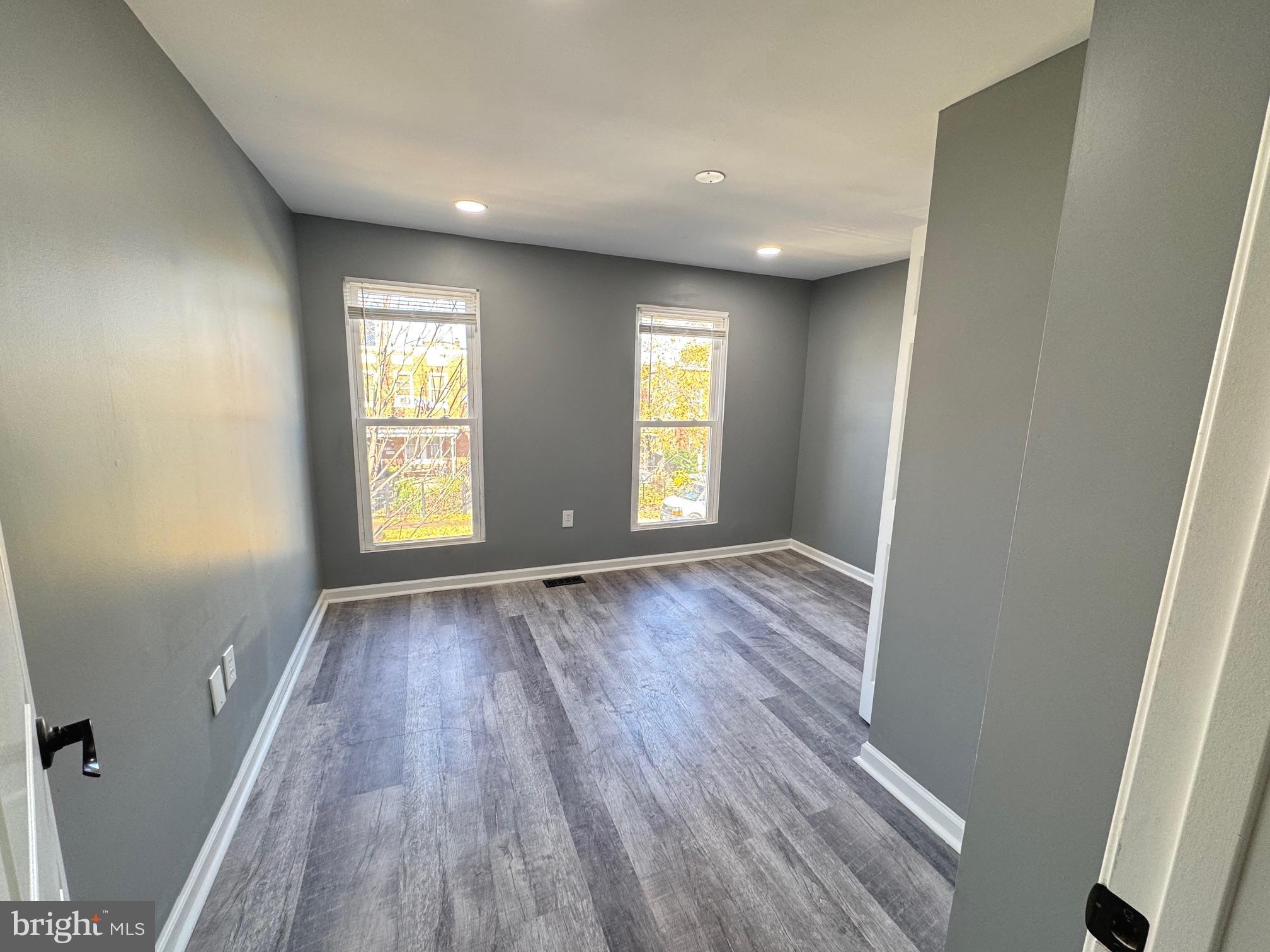 764 Morton Street Northwest Washington, DC 20010 - Photo 12 of 23 an empty room with wooden floor and windows