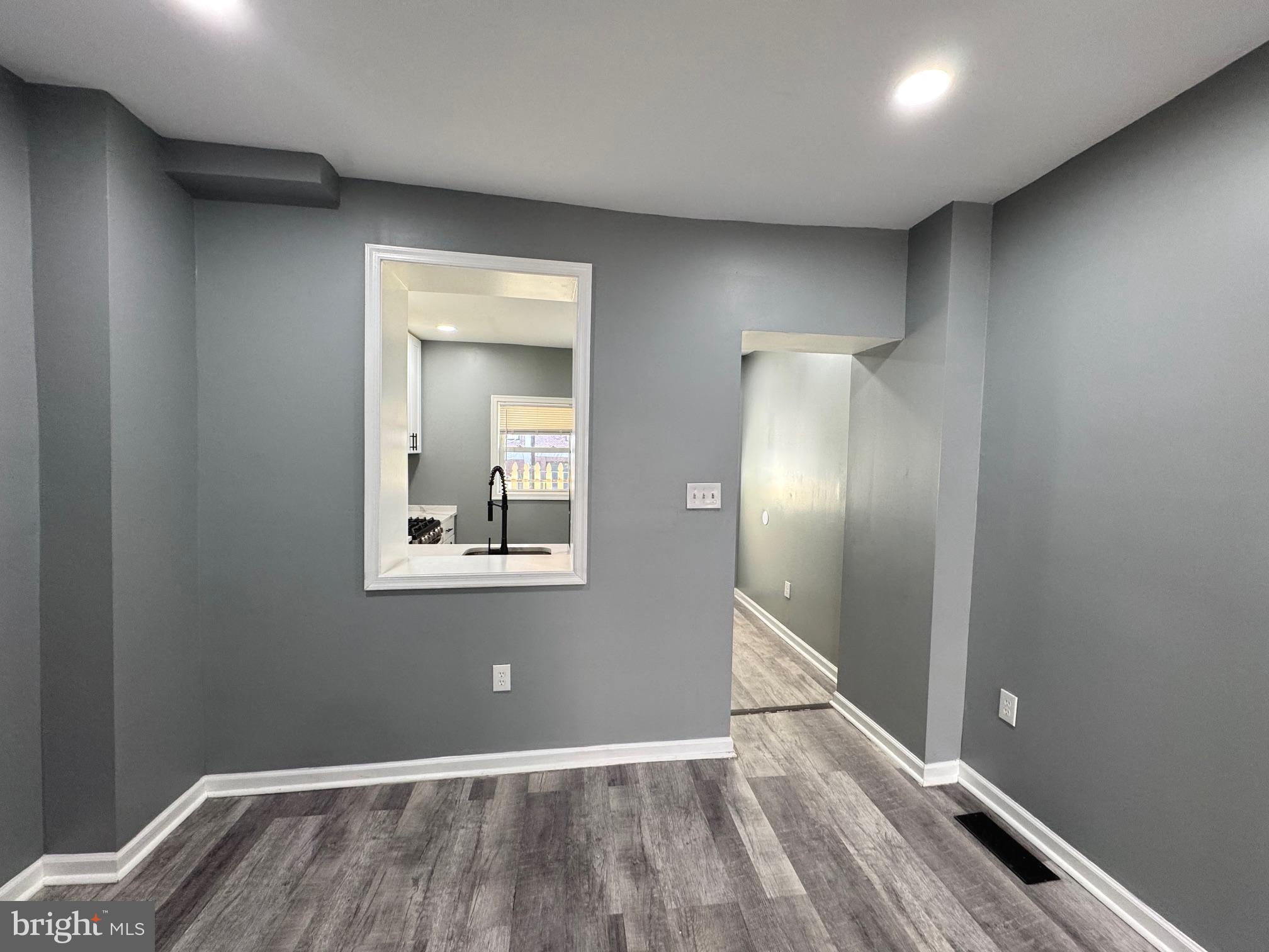 764 Morton Street Northwest Washington, DC 20010 - Photo 17 of 23 a view of an empty room with wooden floor and a window