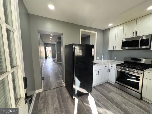 a kitchen with a refrigerator stove and microwave