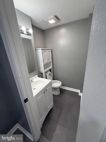 a bathroom with a sink a toilet and mirror