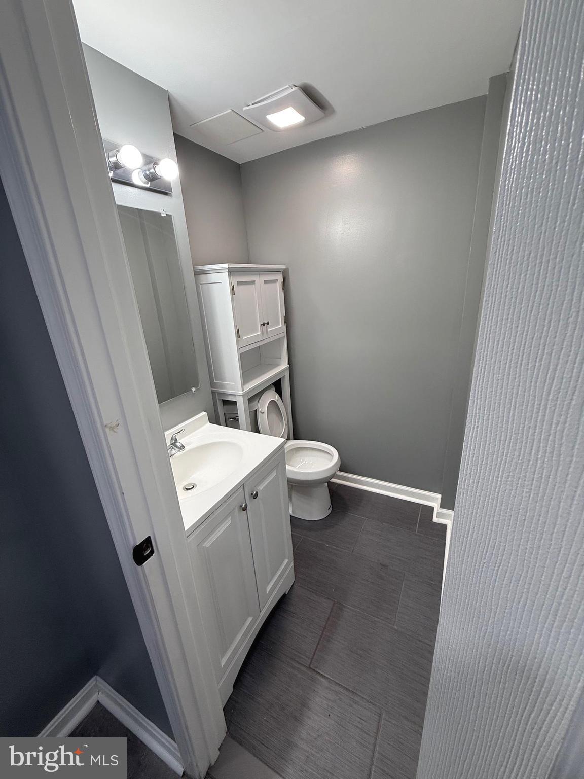 764 Morton Street Northwest Washington, DC 20010 - Photo 20 of 23 a bathroom with a sink a toilet and mirror
