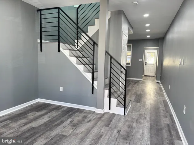 a view of entryway and hall with wooden floor