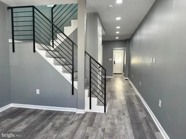 a view of entryway and hall with wooden floor