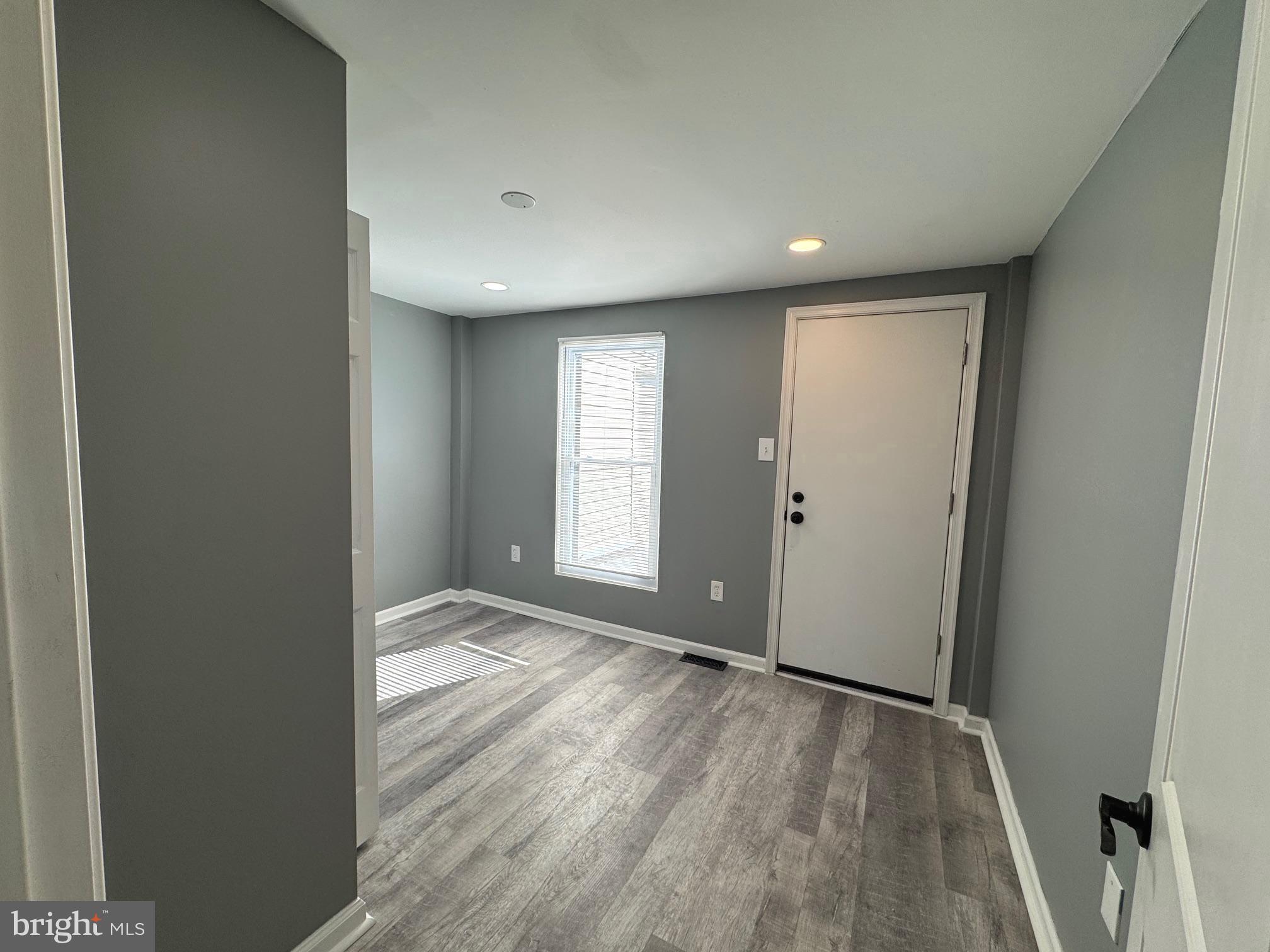 764 Morton Street Northwest Washington, DC 20010 - Photo 10 of 23 an empty room with wooden floor and windows