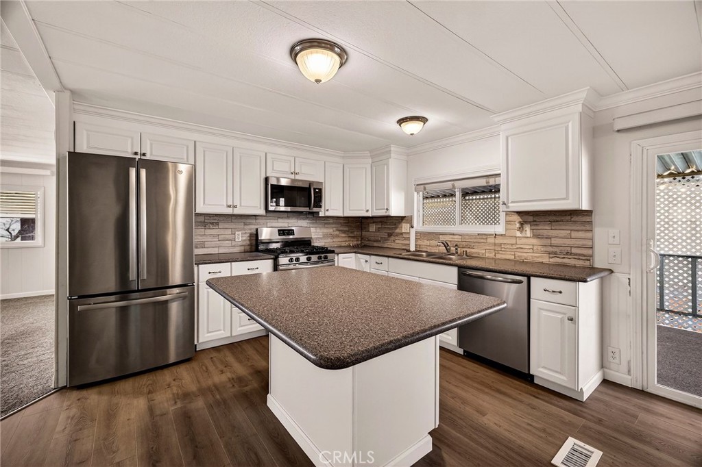 701 East Lassen Avenue, Unit 173 Chico, CA 95973 - Photo 11 of 49 a kitchen with kitchen island a refrigerator stove microwave and sink
