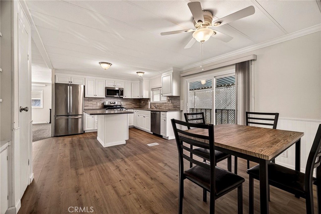 701 East Lassen Avenue, Unit 173 Chico, CA 95973 - Photo 17 of 49 a kitchen with a dining table chairs refrigerator and cabinets