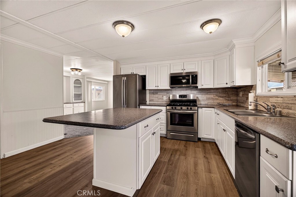 701 East Lassen Avenue, Unit 173 Chico, CA 95973 - Photo 9 of 49 a kitchen with granite countertop a stove top oven and sink