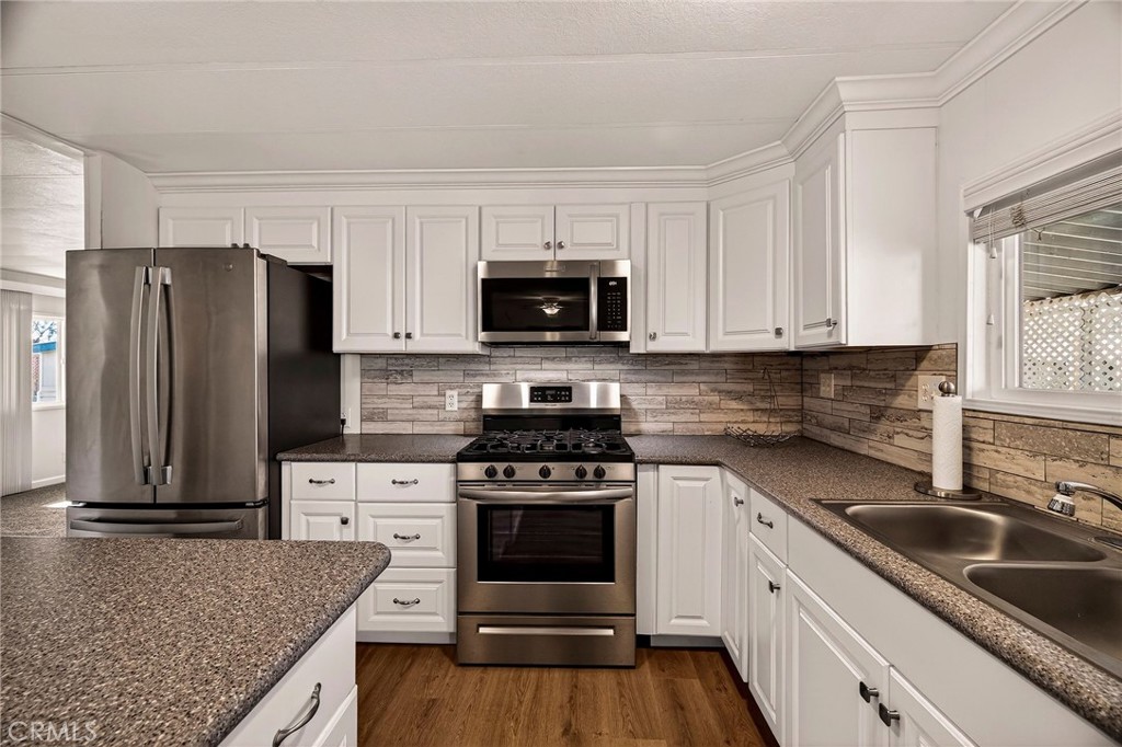 701 East Lassen Avenue, Unit 173 Chico, CA 95973 - Photo 10 of 49 a kitchen with granite countertop a refrigerator stove and sink