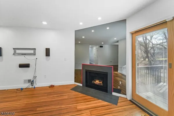 a view of a livingroom with a fireplace and a floor to ceiling window