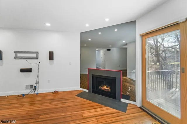 a view of a livingroom with a fireplace and a floor to ceiling window
