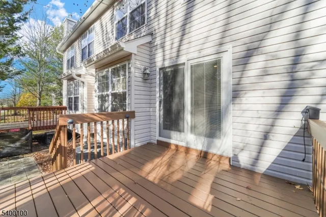 a backyard of a house with barbeque oven table and chairs