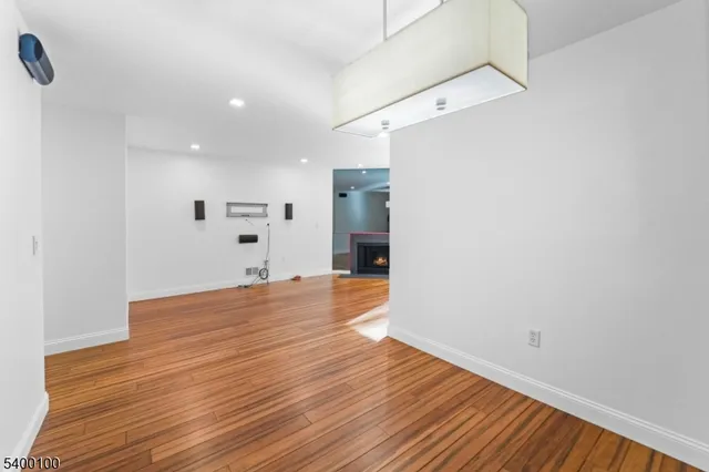 a view of empty room with wooden floor