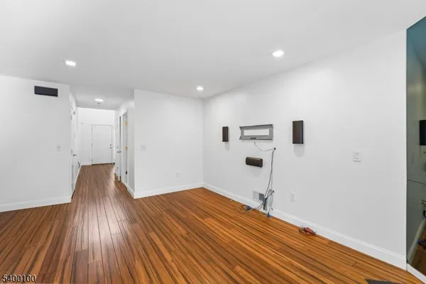 a view of a room with wooden floor and a ceiling fan