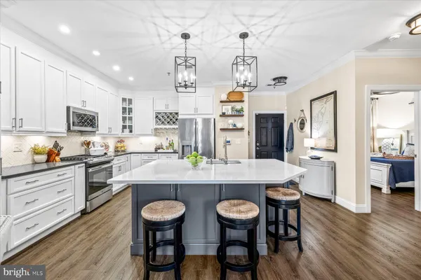 a large kitchen with a table and chairs