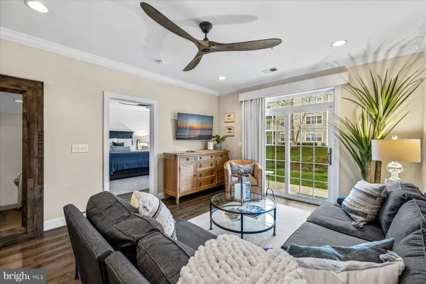 a living room with furniture fireplace and a large window