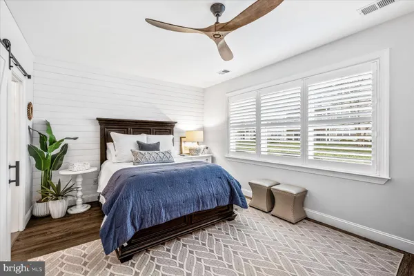 a bedroom with a large bed and a window