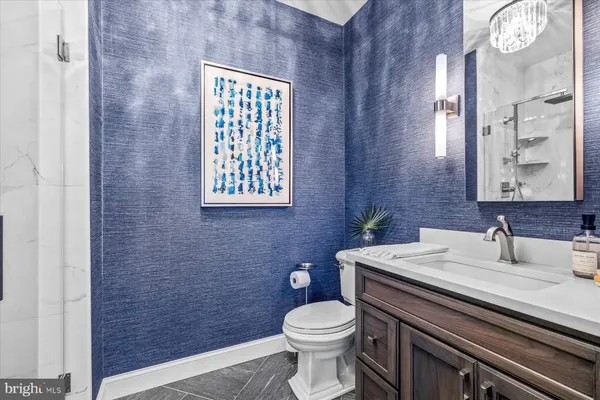 a bathroom with a sink a toilet and mirror